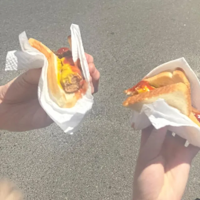 Two sausages in white bread, loaded with ketchup and mustard, from the Bunnings sausage sizzle.